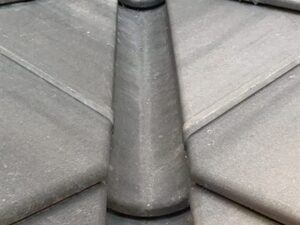 Roof gutter and downspout along a residential eave
